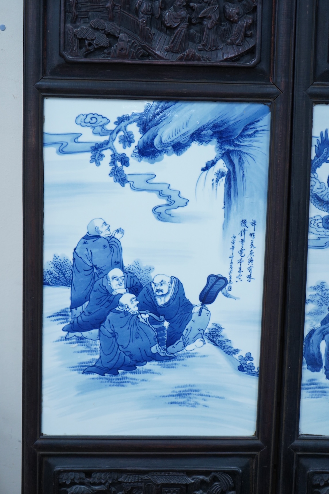 A pair of Chinese blue and white porcelain plaques, inset carved wood frames, 84cm x 32cm